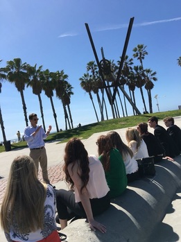 Dr. Griffin lecturing on a beach.